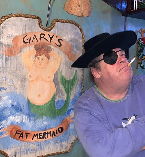 Pirate Gary standing next to the "Gary's Fat Mermaid" sign